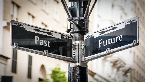 There is a street sign with the names 